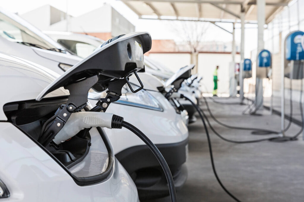 cars plugged into an ev charging station