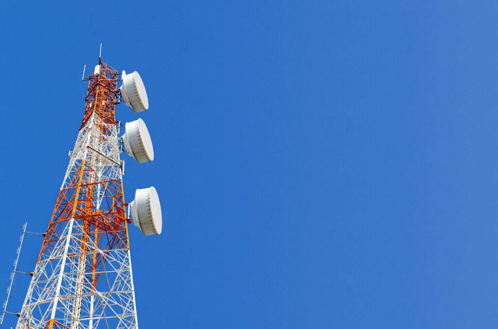 Telecommunication tower on blue sky blank background. Used to transmit television and telephony signal