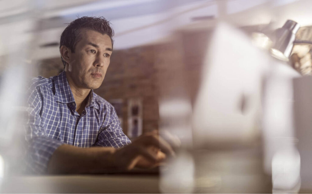 A man works on a laptop