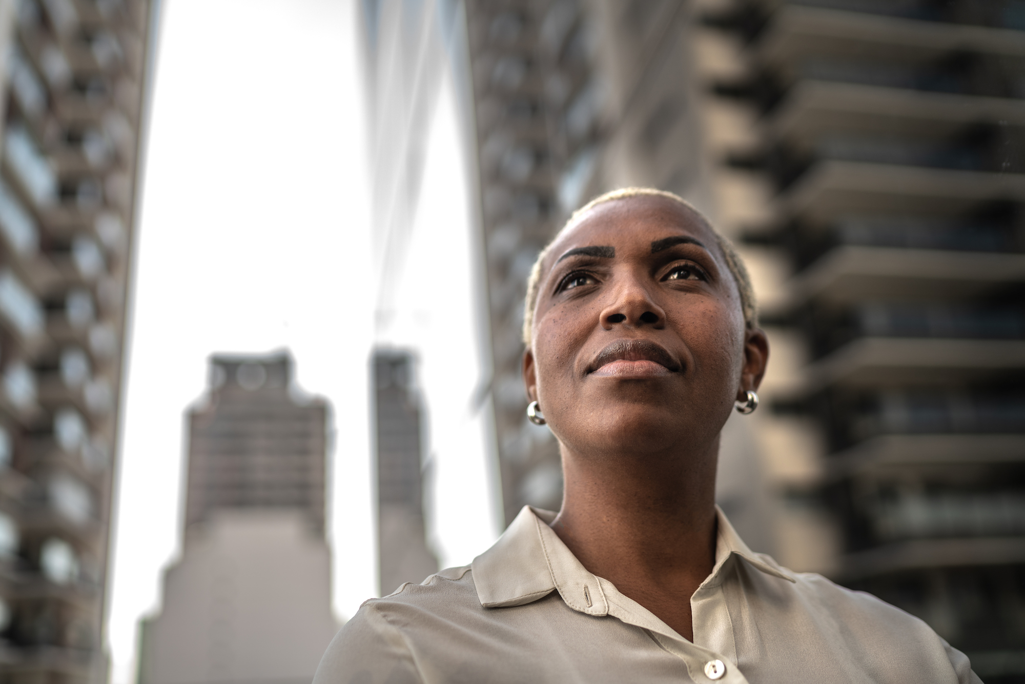 a businesswoman looking away outside in a city