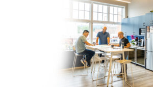 three male professionals collaborating in an office setting