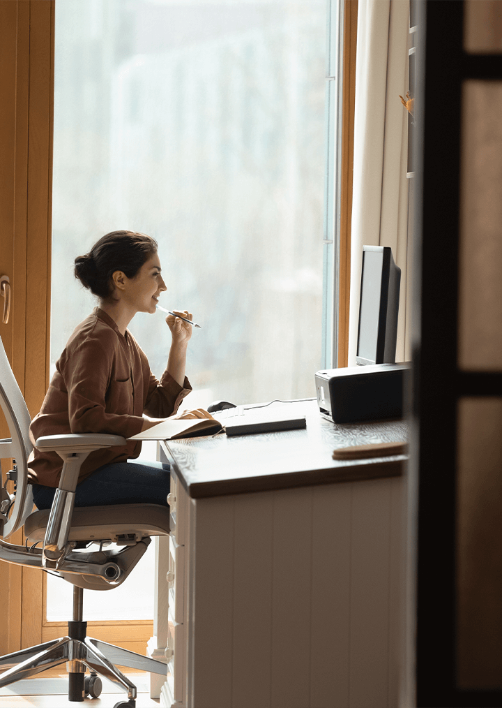 A woman working at a desk on the computer