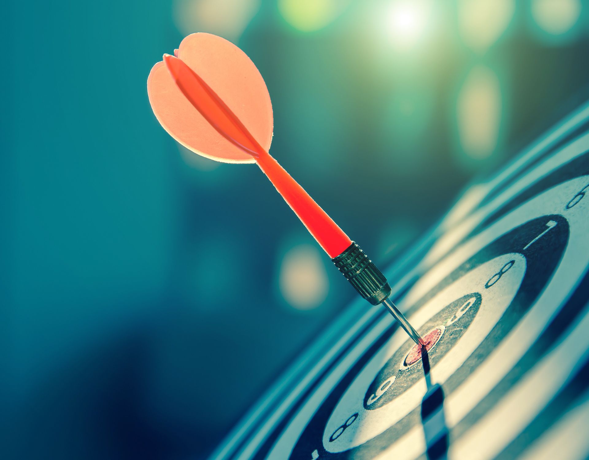 a closeup of a dart on the center of a dart board