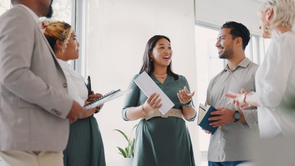 A woman is speaking while her four colleagues listen 