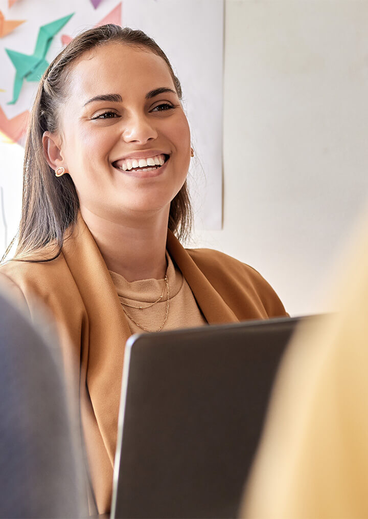 A smiling female professional in an office setting