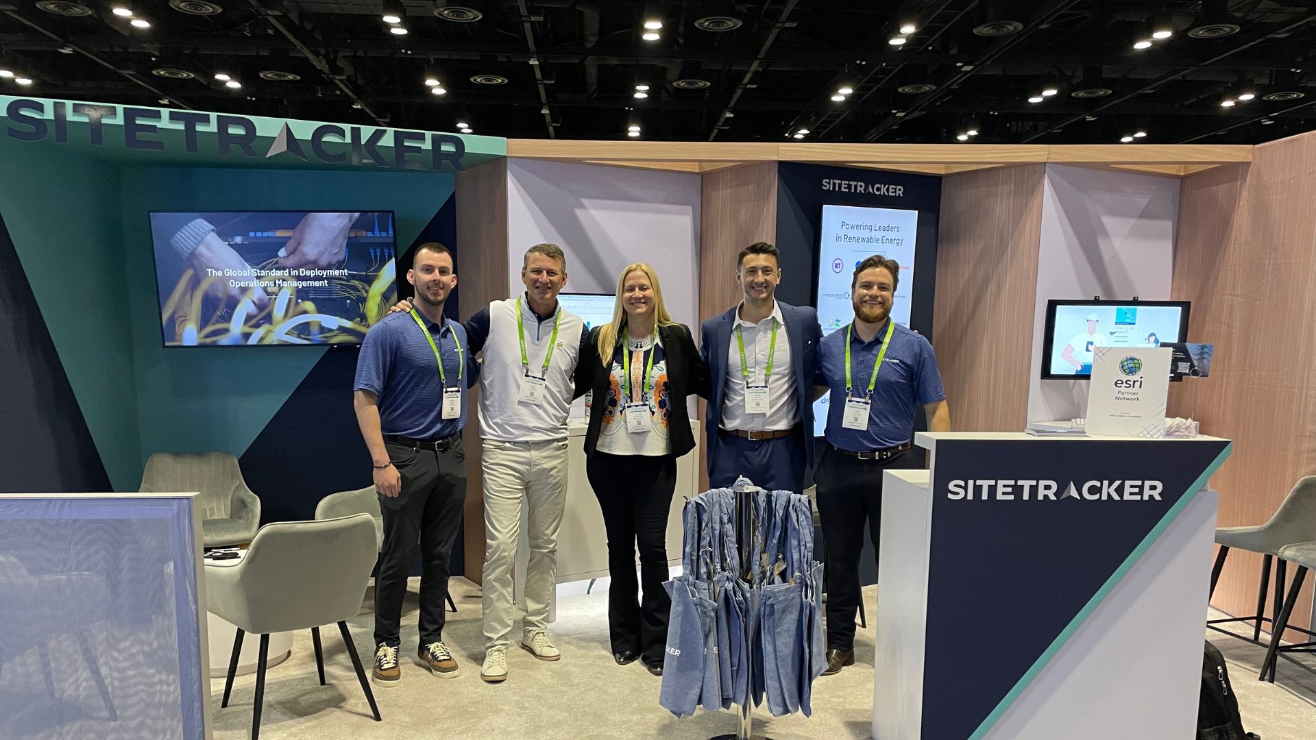 a group of Sitetracker employees in front of the booth at Distributech 2024