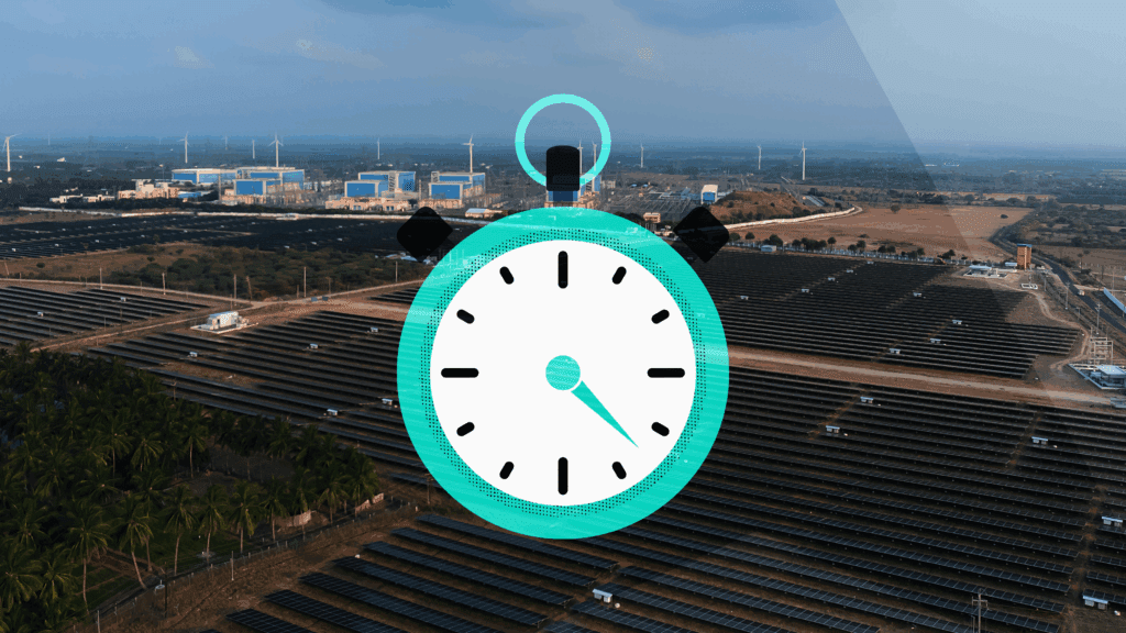 a stopwatch icon over a photo of a field of solar panels and wind turbines