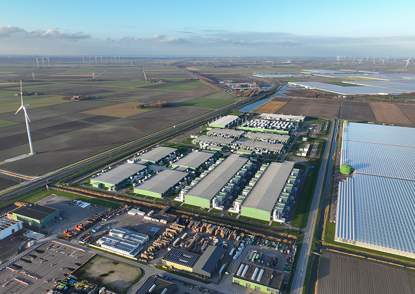 an aerial view of data centers and wind turbines
