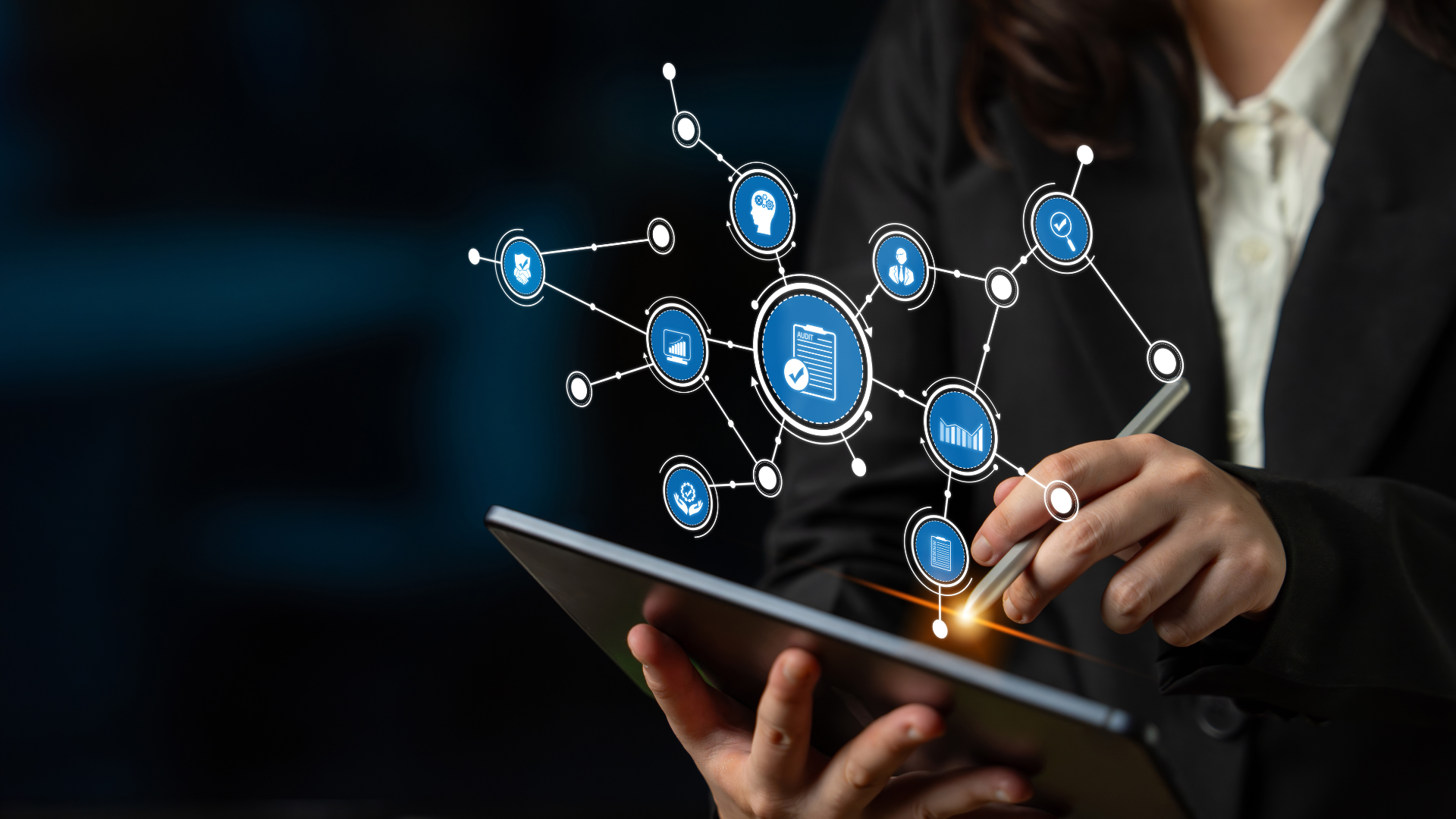 Business professional using a tablet with connected software and data icons floating above the screen
