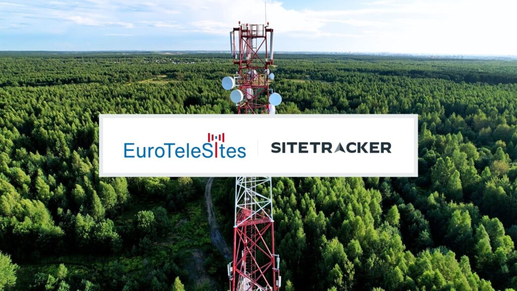 Telecommunications tower with antennas rising above a dense green forest.