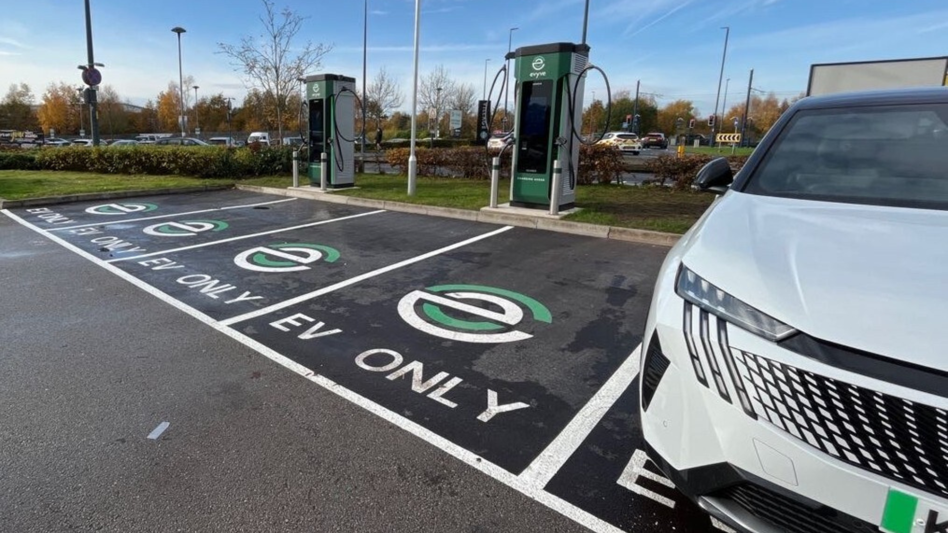 Evyve EV chargers in a parking lot with EV only parking spaces